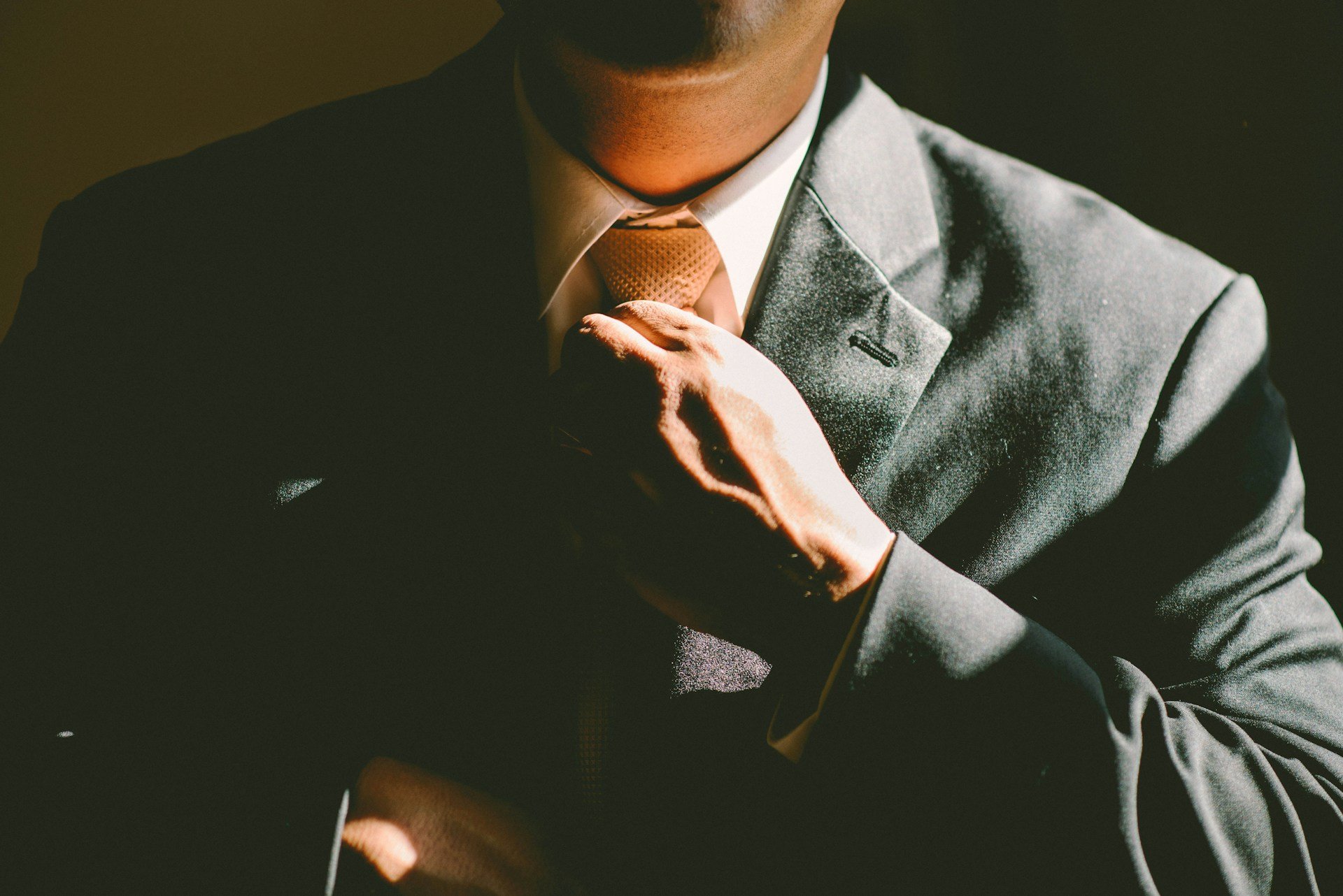 executive adjusting tie